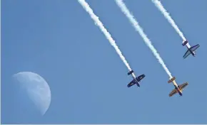  ??  ?? Pilots perform at EAA AirVenture in Oshkosh. The weeklong aviation convention and fly-in starts Monday.