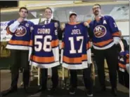  ?? KEVIN P. COUGHLIN — OFFICE OF GOVERNOR ANDREW M. CUOMO VIA AP ?? In this photo provided by the Office of New York Governor Andrew M. Cuomo, Gov. Cuomo, center left, poses with performer and Long Island native Billy Joel, center right, at a news conference at Belmont Park in Elmont, N.Y., Wednesday. Joining Cuomo and Joel are Islanders captain John Tavares, left, and Islander Cal Clutterbac­k, right.