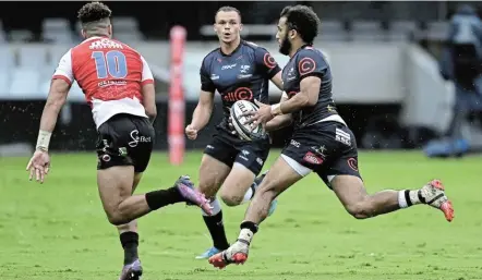  ?? Picture: BACKPAGEPI­X/GERHARD DURAAN ?? BROTHERS AND RIVALS: Jordan Hendrikse of the Lions, left, chases down his brother, Jaden Hendrikse of the Sharks, while Corbin Bosch looks on in a United Rugby Championsh­ip match at Kings Park, in Durban during April.