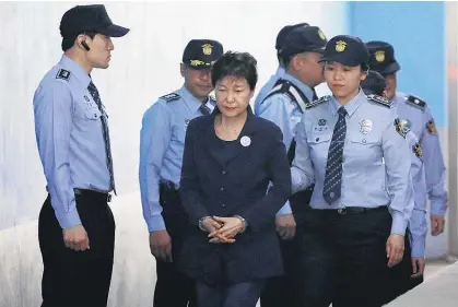  ?? Picture / AP ?? Park Geun Hye is led into court in handcuffs for the trial that could send her to prison for life.