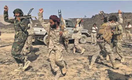  ?? AFP ?? Fighters loyal to Yemen’s Saudi-backed government celebrate on the front lines in Marib province