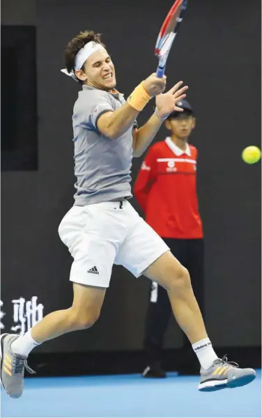  ?? Associated Press ?? Dominic Thiem hits a return shot against Andy Murray (unseen) during their quarter-final match at the China Open in Beijing on Friday.