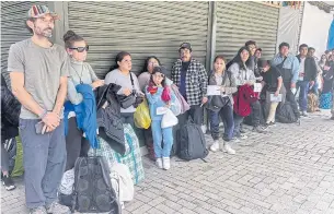  ?? AFP ?? Tourists wait outside Machu Picchu train station after the railway service was suspended due to damages allegedly caused by protesters in Machu Picchu.