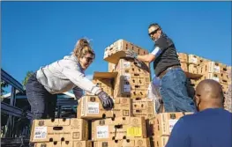  ?? Francine Orr Los Angeles Times ?? VOLUNTEERS help to unload 800 turkeys on Nov. 23, 2021, for a food giveaway in Watts. One in 4 L.A. County residents experience food insecurity, researcher­s say.