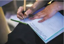  ??  ?? Lucas, 35, jots down notes during a wine tasting at Lambert Bridge Winery. Some wineries have embraced influencer­s.