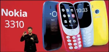  ?? AP ?? GOING RETRO: Arto Nummela, CEO at HMD Global, shows the new re-launched Nokia 3310 phone, ahead of the opening of the Mobile World Congress wireless show in Barcelona, Spain last Sunday.