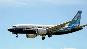  ?? AP ?? A Boeing 737 Max jet heads to a landing at Boeing Field following a test flight in Seattle.