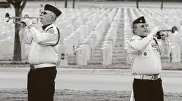  ?? Jerry Lara / Staff file photo ?? Mike Kinkade, left, and Robert Ramirez sound taps during the Veterans Day Ceremony at Fort Sam Houston National Cemetery in 2019.