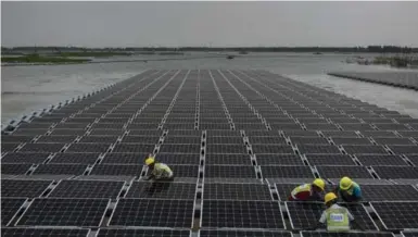  ?? ADAM DEAN/THE NEW YORK TIMES ?? China has built the world’s largest floating solar farm at the site of an abandoned coal mine in a push for renewable energy.