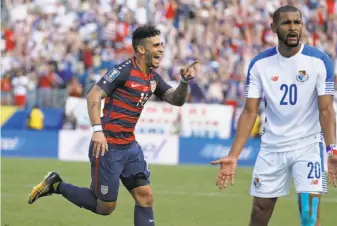  ?? Mark Humphrey / Associated Press ?? Dom Dwyer of the U.S. celebrates behind Panama’s Anibal Godoy (20) after scoring a goal.