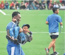  ?? — Reuters photo ?? Former Chelsea player Michael Essien jokes with a young fan of his new club Persib in Bandung, Indonesia.