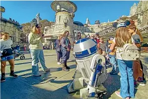  ?? ?? R2-D2 greets fans at Star Wars land, Disneyland Park.