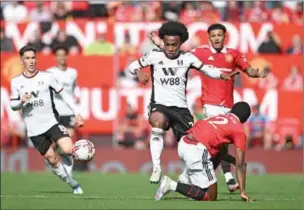  ?? (AFP) ?? Manchester United’s Dutch defender Tyrell Malacia (R) fouls Fulham’s Brazilian midfielder Willian during the English Premier League match between Manchester United and Fulham at Old Trafford in Manchester, England, on Sunday.