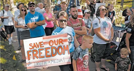  ?? RICK BOWMER/AP ?? Protesters are seen in an anti-mask rally outside the Utah governor’s mansion last month. In the 1980s, some Americans decried seat belt use.