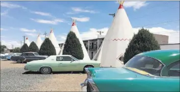  ?? ANDREA SACHS/THE WASHINGTON POST ?? Guests sleep in teepees at Holbrook, Arizona’s Wigwam Motel, one of only three surviving outposts from a chain built in the 1930s. Vintage cars add to the old-timey feel.