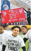  ?? AFP-Reuters-Yonhap ?? In the upper photo, fans hold a banner against the Super League and Liverpool FC’s involvemen­t outside Elland Road ahead of the English Premier League football match between Leeds United and Liverpool in Leeds, northern England, Monday. In the below photo, Leed’s Ian Poveda is wearing a t-shirt with the message against the Super League during the warm-up before the match.