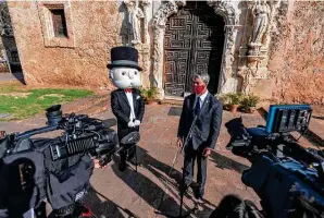  ?? William Luther / Staff photograph­er ?? Uncle Pennybags, the Monopoly Man, stands near Mayor Ron Nirenberg in front of Mission San José as a San Antonio version of the official Monopoly game is announced.