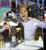 ?? DAVID J. PHILLIP — THE ASSOCIATED PRESS FILE ?? In this file photo, John Sun reacts as he sees the Vince Lombardi Trophy on display inside the NFL Experience in San Francisco. This year, the Lombardi Trophy will be on display at the NFL Experience at the George R. Brown Convention Center in Houston...