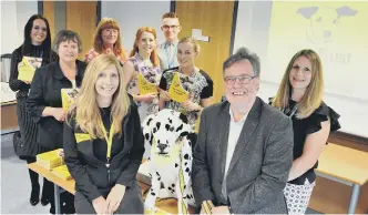  ??  ?? Alison Gray, NE education and community officer at Dogs Trust, and Sir Paul Ennals, chairman of Sunderland Safeguardi­ng Children Board with health visitors and staff from the Sunderland Safeguardi­ng Children Board at a Dogs Trust workshop at Riverview...