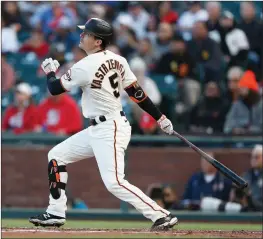  ?? Thearon W. Henderson / Getty Images /TNS (top); Lachlan Cunningham / Getty Images /TNS (above) ?? Buster Posey (28) of the San Francisco Giants (top) hits a three-run home run against the Arizona Diamondbac­ks in the bottom of the first inning at Oracle Park on June 16 in San Francisco. Mikeyastrz­emski of the San Francisco Giants (above) hits an RBI double in the second inning against the St. Louis Cardinals at Oracle Park on July 7 in San Francisco.