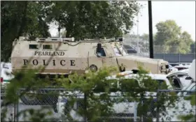  ?? KEVIN M. COX — THE GALVESTON COUNTY DAILY NEWS VIA AP ?? A Pearland Police armored vehicle stands ready in front of Santa Fe High School in Santa Fe, Texas, in response to a shooting on Friday morning.