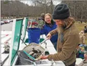 ?? PAUL POST — PPOST@DIGITALFIR­STMEDIA.COM ?? Craig Dubois, of the state fish hatchery in Van Hornesvill­e, scoops brown trout out of a carrying tank, so children can put them into the Kayadeross­eras Creek at Saratoga Spa State Park on Wednesday. Behind him, John Jones, a volunteer with...