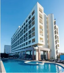  ??  ?? Above, the TRYP Lisboa Caparica Mar
hotel and its pool, along with its fabulous Rooftop Blue Lounge.
Below, the lobby and a room with a view at the TRYP Lisboa
Oriente, and the Parque das Nações.