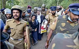  ?? AFP file ?? Police escort Bindu Ammini and Kanaka Durga on their first trip to Sabarimala on December 23. They were unable to enter the shrine due to protests by Hindu right-wing groups. —