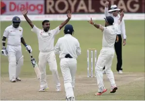  ?? PICTURE: REUTERS ?? Spinner Amit Mishra celebrates a Test wicket with his teammates.