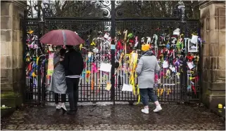  ??  ?? Remembranc­e: Tributes to Sarah Everard and Moira Jones at Queen’s Park, Glasgow. Above, candles lit at Holyrood