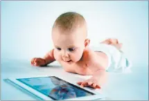  ?? PHOTO BY THINKSTOCK ?? A baby plays with an iPad. Recent studies show that touch screens can interfere with a baby or toddler’s sleep.