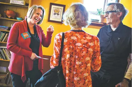  ?? CRAIG FRITZ/FOR THE NEW MEXICAN ?? Stephanie Garcia Richard, left, candidate for state land commission­er, speaks with Teri Roberts and her husband, Lawrence Kay, who is running for Bernalillo County probate judge, during a meeting last week of the Cedar Crest Drinking Liberally social...