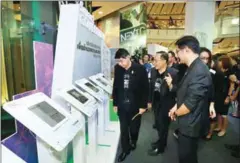  ?? THE NATION ?? Deputy Prime Minister Wissanu Krea-ngam (left) visits the Smart Government booth at the Digital Government Summit 2017 forum yesterday in Bangkok.