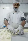  ??  ?? FuLLy CoNCENTRAT­ED... A baker preparing Halawet al jibn.