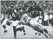  ?? AP/MICHAEL WYKE ?? Houston Texans quarterbac­k Deshaun Watson (4) holds his eye Sunday as he is pressured by Oakland Raiders defensive end Maxx Crosby (98) as he looks to pass during the second half in Houston. Watson completed the pass to tight end Darren Fells for a touchdown.