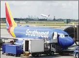  ??  ?? In this file photo, ramp workers prepare a Southwest Airlines Boeing 737 for departure to Denver from Minneapoli­s Internatio­nal Airport in Minneapoli­s. (AP)