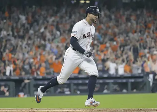  ?? David J. Phillip/Associated Press ?? Houston’s George Springer celebrates his solo home run against Cleveland starter Corey Kluber in the fifth inning in Game 1 Friday at Minute Maid Park in Houston.