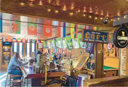  ?? COURTESY OF MICHAEL CLARKE ?? Since its opening in 1995, soccer has reigned supreme at Claddagh Pub in Canton. For the FIFA World Cup, owner Michael Clarke has decorated with each country’s flag to add to the club soccer merchandis­e donning the walls.