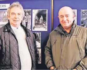  ?? ?? Family memories Cousins Scott and Kenny Filson who are in front of a picture which shows their late fathers, who were also miners