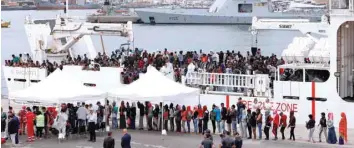  ?? — Reuters ?? Migrants disembark Italian coast guard vessel “Diciotti” as they arrive at the port of Catania, Italy, on Wednesday.