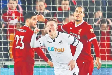  ??  ?? Swansea City’s Alfie Mawson celebrates after scoring against Liverpool at The Liberty Stadium in Swansea, south Wales. — AFP photo