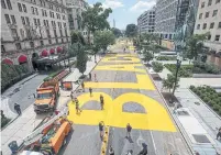  ?? TASOS KATOPODIS TRIBUNE NEWS SERVICE ?? People walk down 16th Street in Washington after city workers and volunteers painted “Black Lives Matter” in large letters.