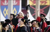  ??  ?? Students wave to their families in the football stadium stands before the start of the ceremony.