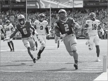  ?? MARY SCHWALM/AP PHOTO ?? Boston College running back AJ Dillon (2) scores a touchdown during the first quarter of Eagles’ win over Temple last Saturday. Dillon, a New London native, later left with a left ankle injury and his status of today’s ACC game at No. 23 North Carolina State is up in the air.