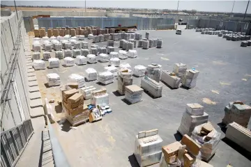  ??  ?? Packages of goods are seen ahead of their transfer to the Gaza Strip, inside the Kerem Shalom border crossing terminal between Israel and Gaza Strip. — Reuters photo