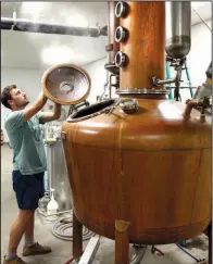  ?? Arkansas Democrat-Gazette file photo ?? Luke Klifman opens the copper pot while working at Rock Town Distillery in a 2016 file photo.
