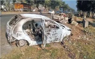  ?? - PTI ?? TORCHED: Charred remains of vehicles which were set on fire by Jat protesters demanding reservatio­n, at GT Road near Sonipat on Monday.