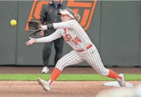  ?? BRYAN TERRY/THE OKLAHOMAN ?? Oklahoma State’s Karli Petty has become extremely valuable as a versatile fielder, starting games at four different positions this season.