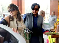  ??  ?? File photo taken on March 12, 2012 shows Tharoor (right) with his wife Pushkar arrive at parliament for the opening of the budget session in New Delhi. — AFP photo