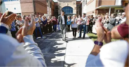  ?? Karen Warren / Houston Chronicle ?? Katy ISD Superinten­dent Lance Hindt, accused of bullying more than 40 years ago, is surrounded by about 150 members of the Katy community who organized a support circle before the board of trustees work-study meeting on Monday.